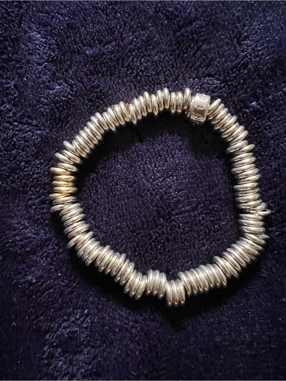 Links of London “Sweetie” Stretch Bracelet with 5 gold-tone accent rings.